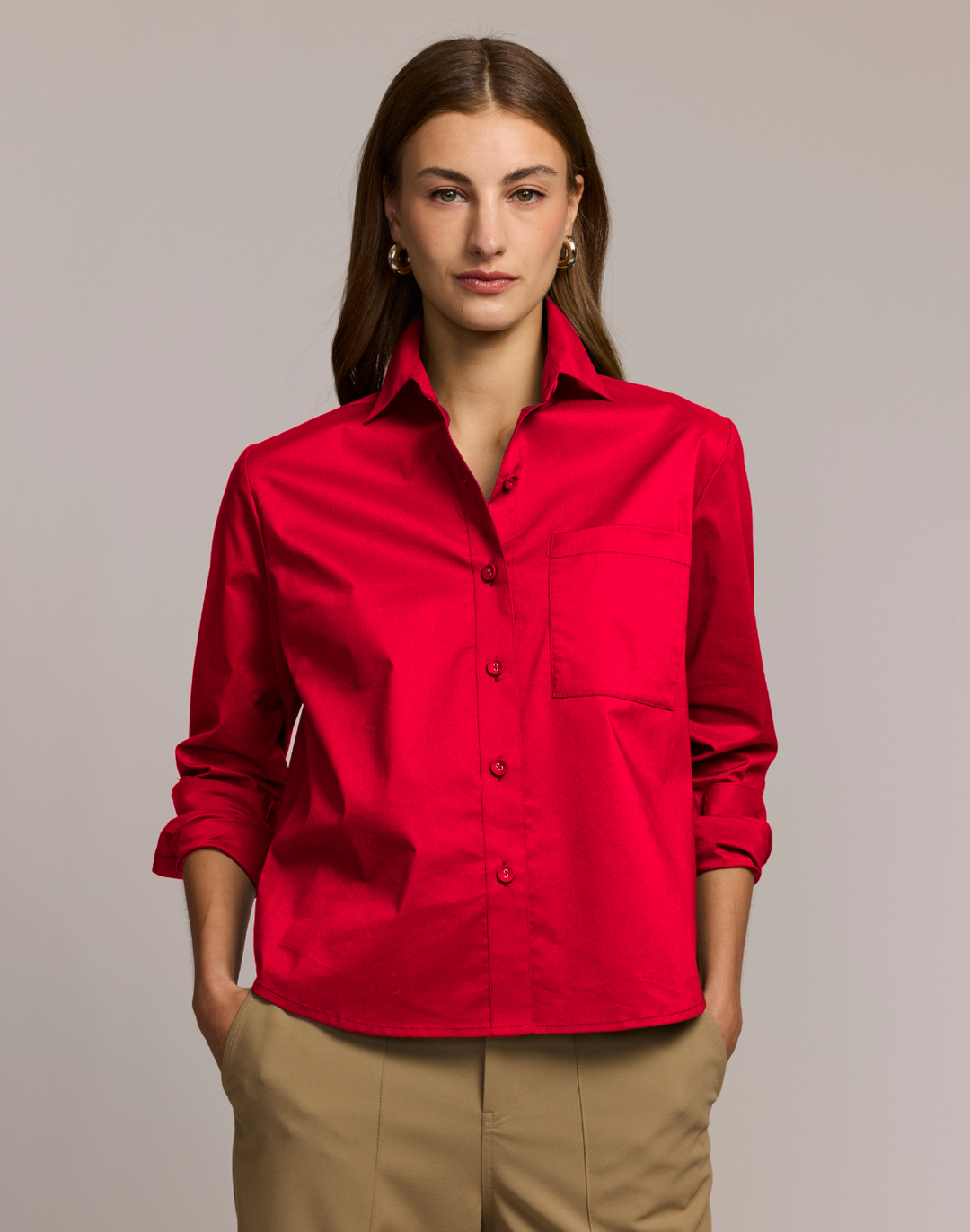 Woman wearing a red shirt against a plain background