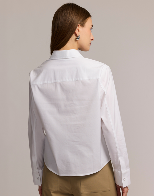 Woman wearing a white shirt with a plain background