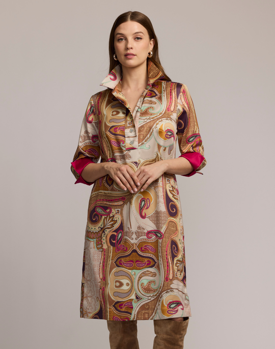 Woman wearing a scarf patterned dress with a neutral background