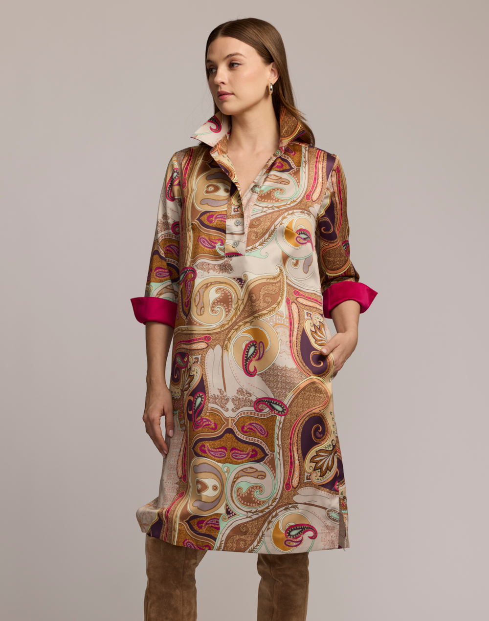 Woman wearing a scarf patterned dress with a neutral background