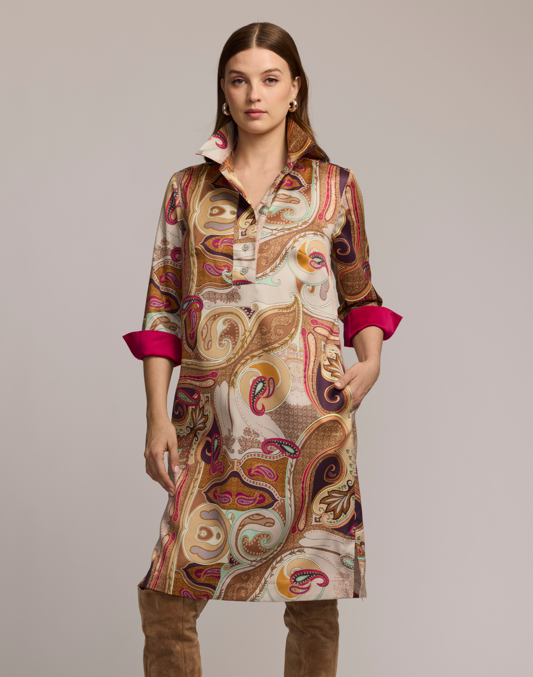Woman wearing a scarf patterned dress with a neutral background