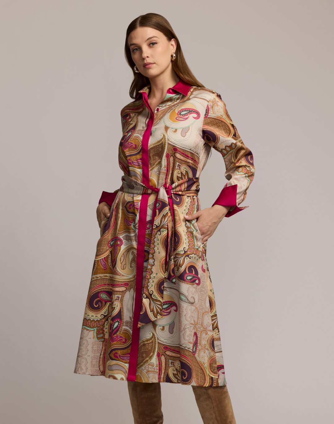 Woman wearing a scarf patterned dress with a plain background