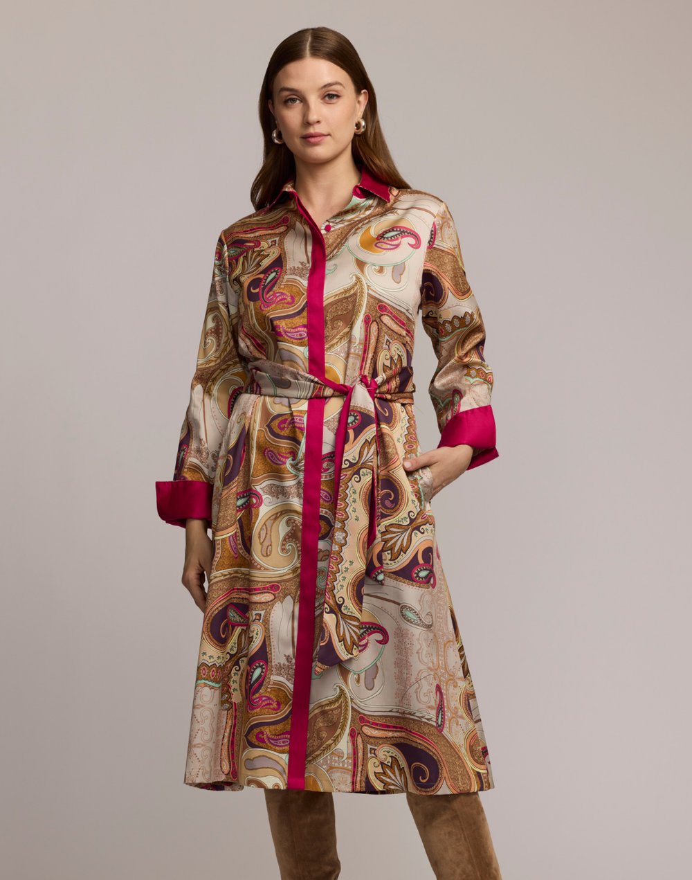 Woman wearing a scarf patterned dress with a plain background