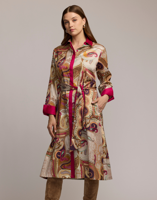 Woman wearing a scarf patterned dress with a plain background