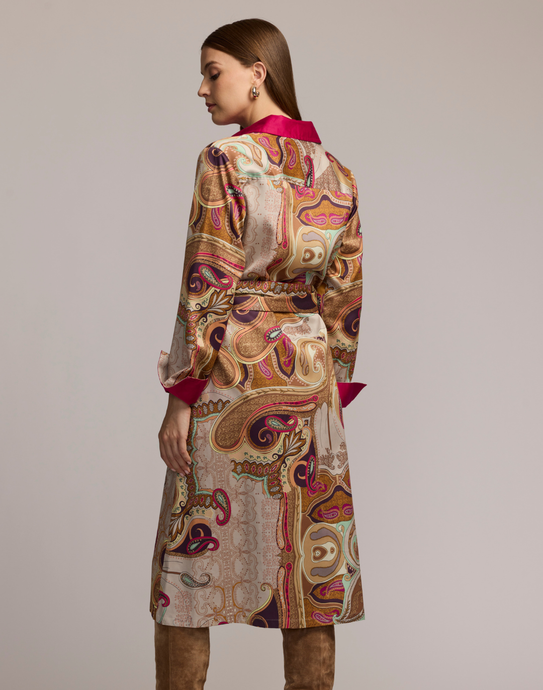 Woman wearing a scarf patterned dress with a plain background