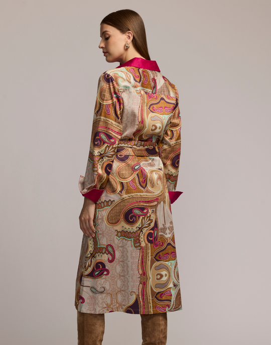 Woman wearing a scarf patterned dress with a plain background